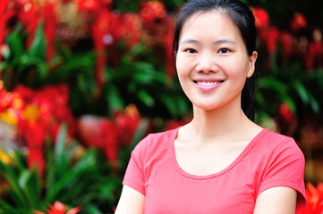 young woman florist smile infront red flowers