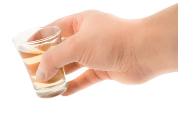 Man's hand holding a glass with tekila, tequila
