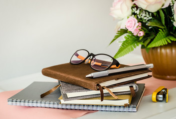 Eyeglasses and silver pen on notebook,Still life