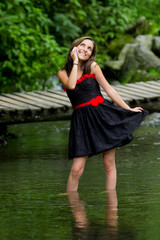 Young attractive woman wearing a dress, speaking on mobile