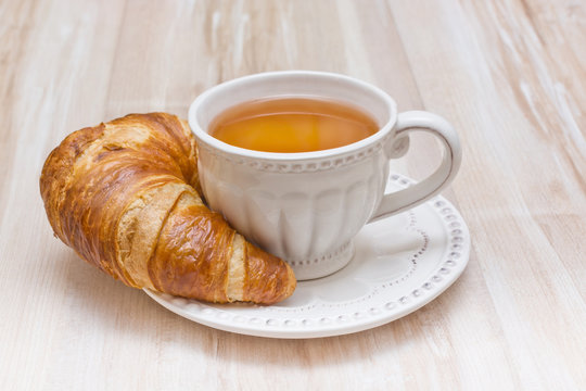 Breakfast concept croissant and tea