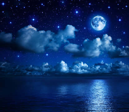 super moon in starry sky with clouds and sea