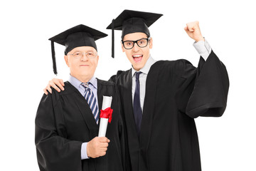 Mature and younger college student celebrating graduation