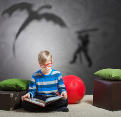 Preteen boy reading a story about a knight and a dragon