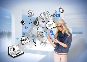 Obraz premium Stylish blonde using tablet pc with app icon doodles