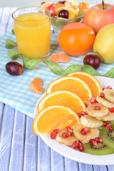 Sweet fresh fruits on plate on table close-up