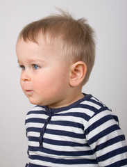 Serious little boy looking forward