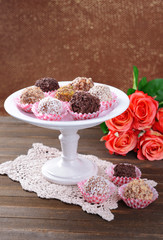 Set of chocolate candies on table on brown background
