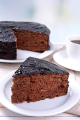 Delicious chocolate cake on plate on table on light background