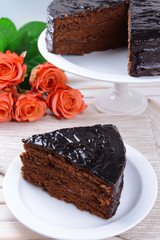 Delicious chocolate cake on plate on table on light background