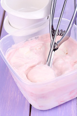 Ice cream in container and ice cream spoon