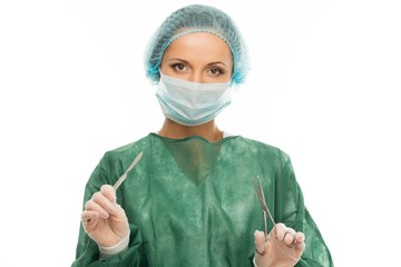 Young woman doctor with surgery scalpel and scissors