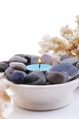 Fototapeta na wymiar Spa stones with candle isolated on white