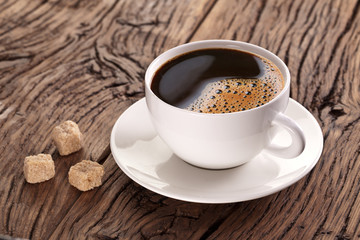 Cup of coffee on the old wooden table.