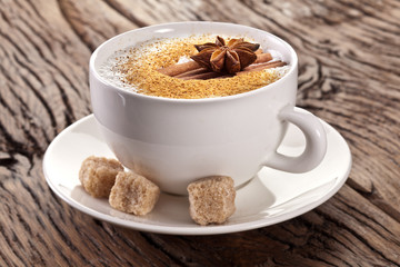 Cup of cappuccino decorated with spices.