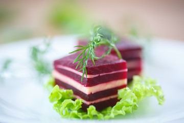 appetizer of beet and cheese on lettuce leaves