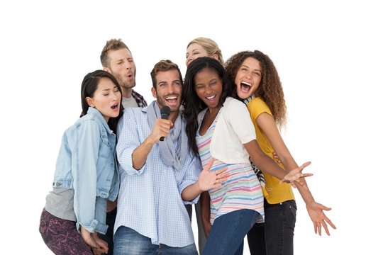 Group of happy people singing into microphone