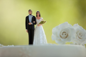 Close-up of figurine couple on wedding cake