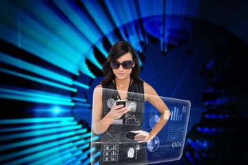 Glamorous brunette using smartphone with interface
