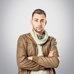 Obraz premium Handsome man with arms crossed over grey background