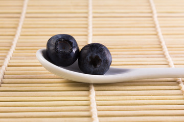 spoon with two huckleberries