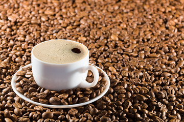 Cup in coffee beans