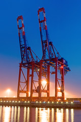 Two container cranes in Hamburg at night