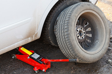 lifting car by hydraulic jack © vvoe