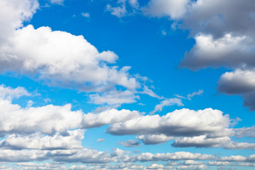 white woolpack clouds in blue sky