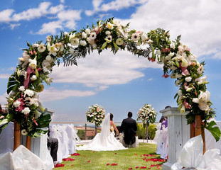 outdoor ceremony with boyfriends background with flowers and bow