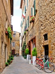 Narrow small town lane in Pienza, Tuscany, Italy with bikes