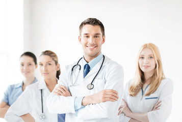 Fototapeta premium male doctor in front of medical group