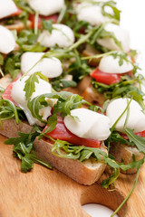 Tomato, mozzarella and arugula sandwich