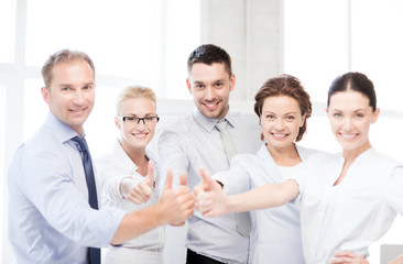 business team showing thumbs up in office