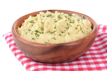 Delicious mashed potatoes with greens in bowl on table close-up