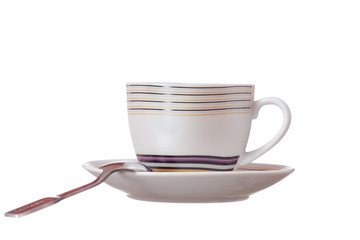 teacup and saucer with a spoon on a white background