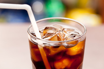 glass of cola with ice on the bar