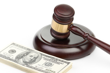 Law gavel on a stack of American money.
