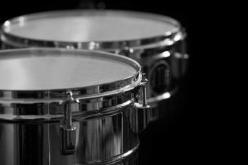 Fototapeta na wymiar Detail of drums on a black background
