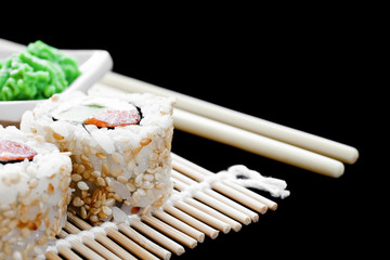 Detail of sushi on a mat on a black background