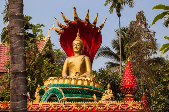 Buddha statue seated on lotus flower at Wat That Luang Tai