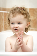 Little child washing hands in the bath