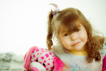 Adorable little girl going to sleep in the bed