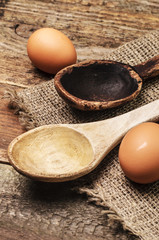 Two wooden spoons and two eggs