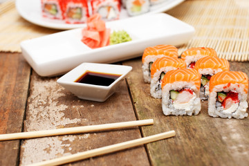 Salmon sushi set with soy sauce and chopsticks