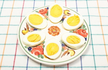 Halves of eggs lying on colorful plate