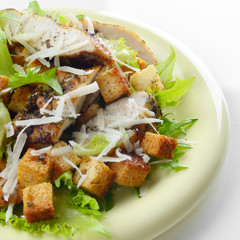 Caesar chicken salad on white background