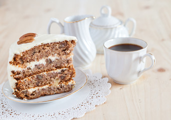 A single piece of Hummingbird cake with pecans and cream cheese
