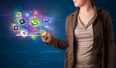 Lady holding a tablet with modern colorful apps and icons