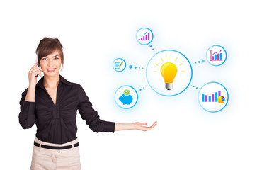 Young woman presenting light bulb with colorful graphs and diagr